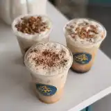Three iced fall lattes topped with sweet cream, cinnamon and pecan crunch